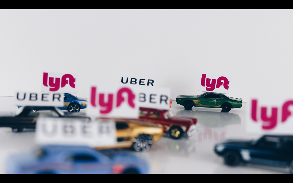 Tiny toy cars with UBER and lyft signs