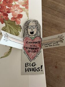 Drawing of me with arms oustretched in front of a heart and text: "Congrats on the sweet gig! this is a heart, not my boobs."